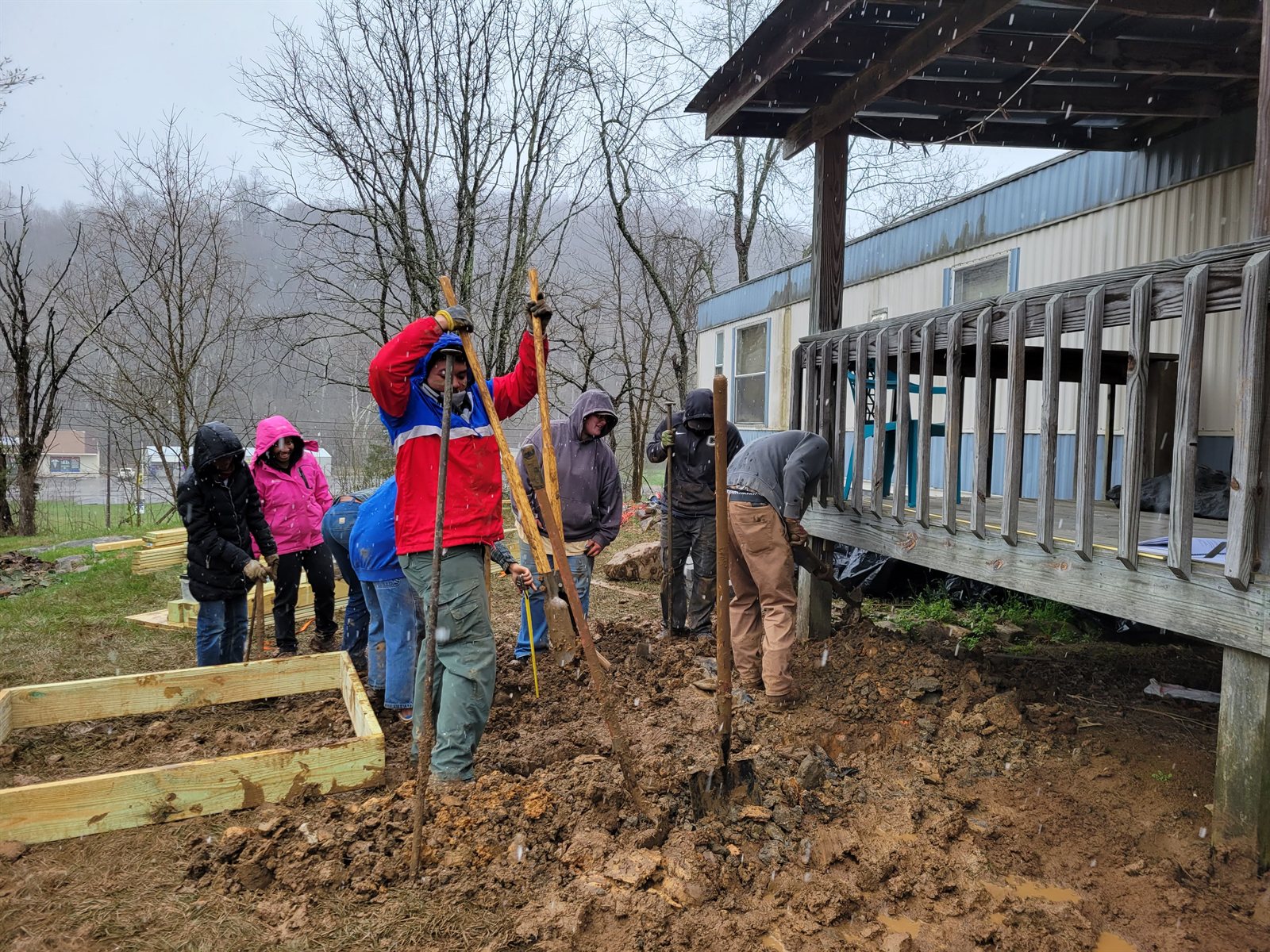 Working together on an outdoor building project in snowy weather