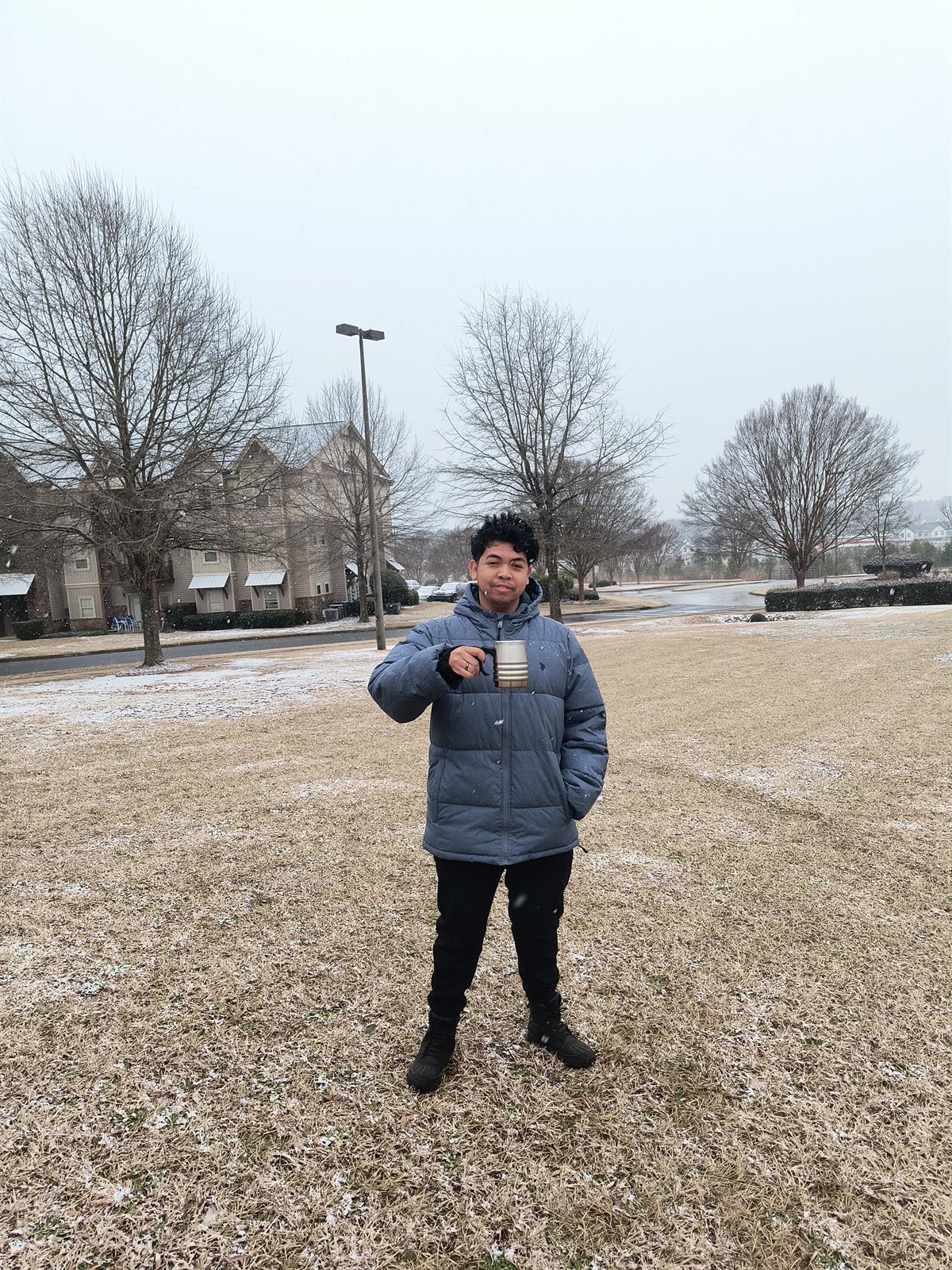 Enjoying a warm drink outdoors as snow falls